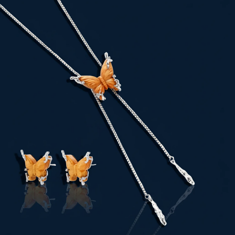 Amber wood butterfly pendant necklace with dangling chains and matching carved wood butterfly earrings on white background.