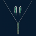 White gold plated jewelry set with emerald green rectangular stones and clear crystals in geometric rows on white background.